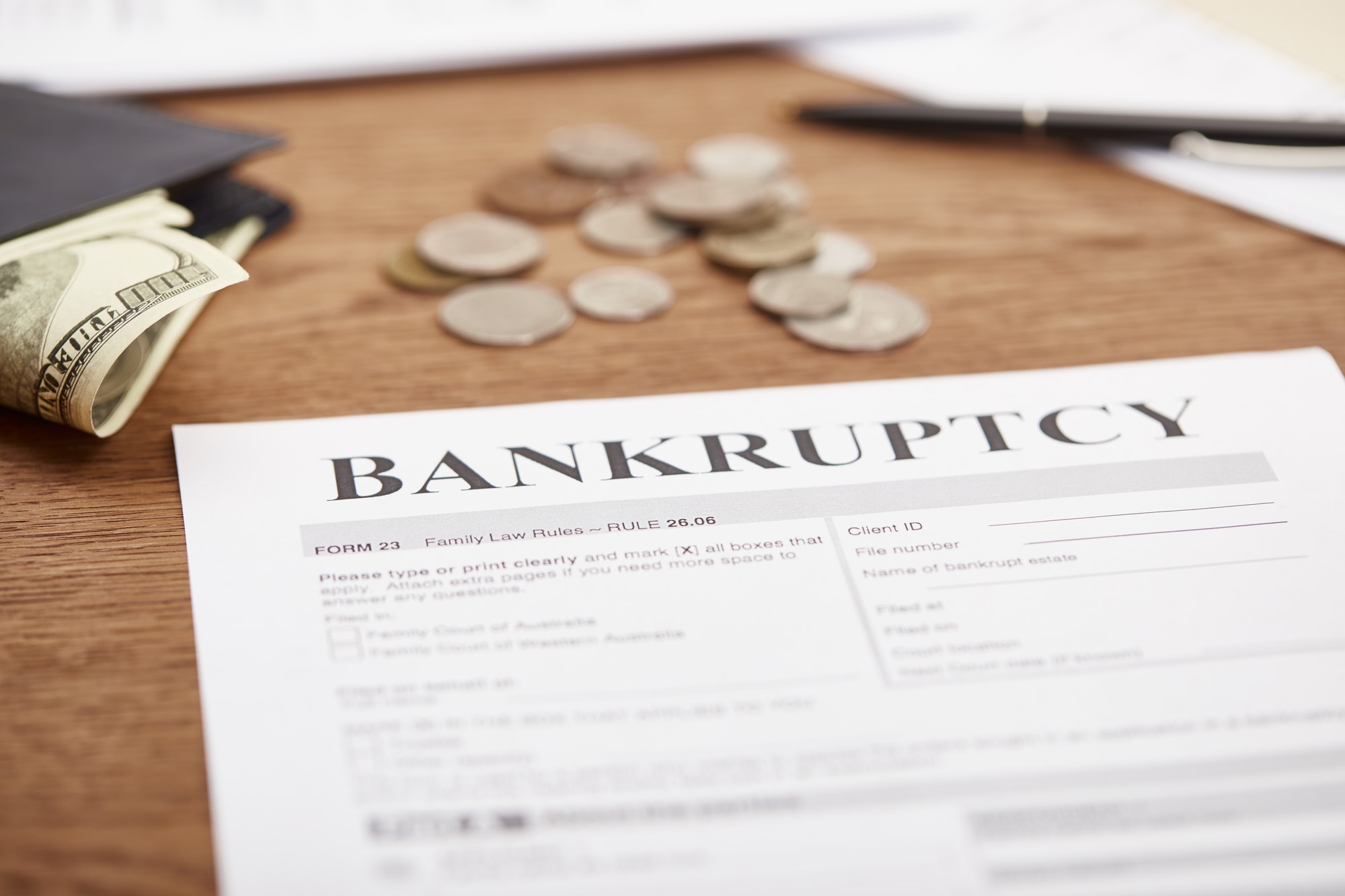 Bankruptcy Forms and moeny on a table