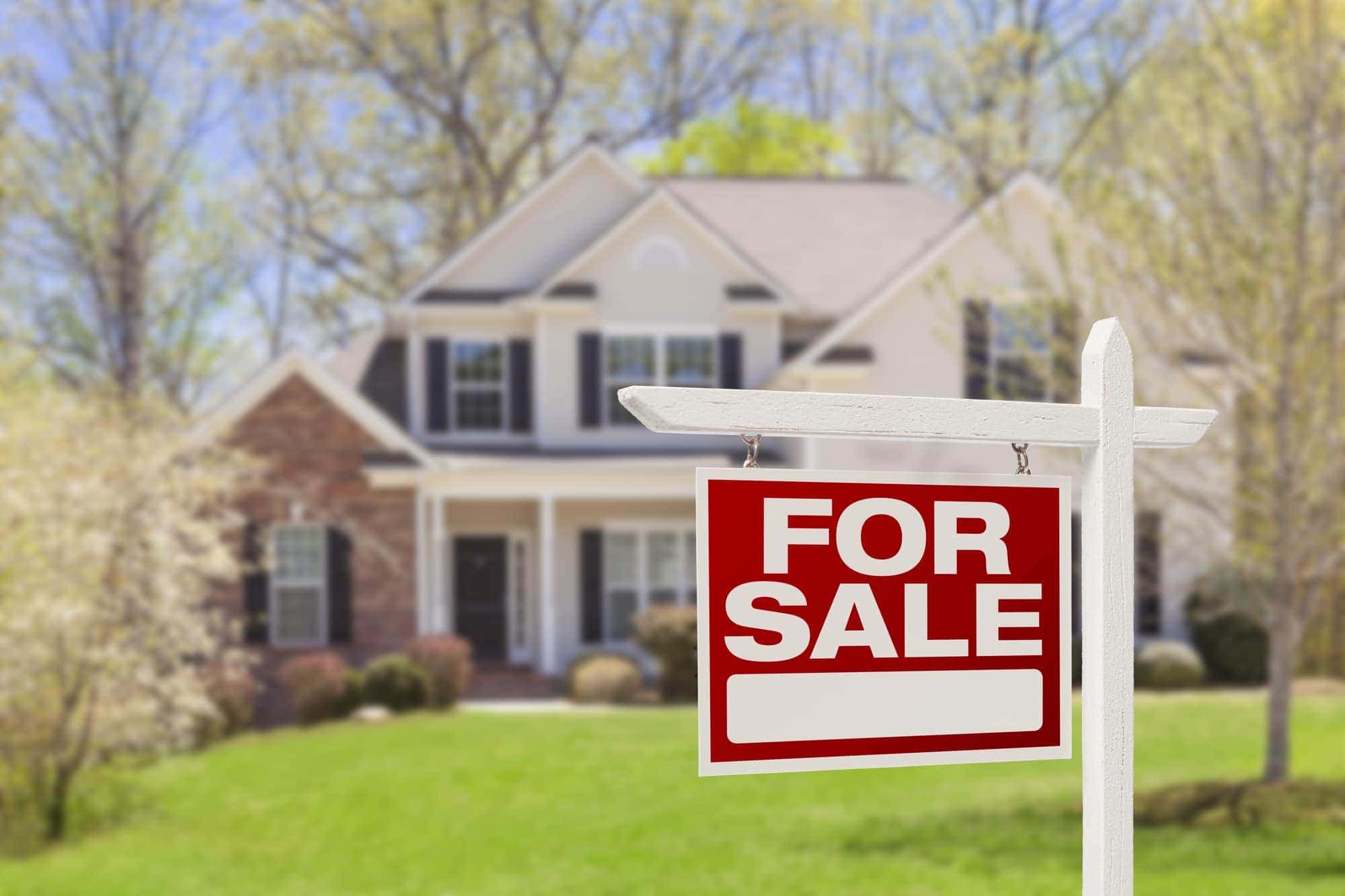 Home For Sale Real Estate Sign and Beautiful New House. Real Estate Lawyer Greensboro NC