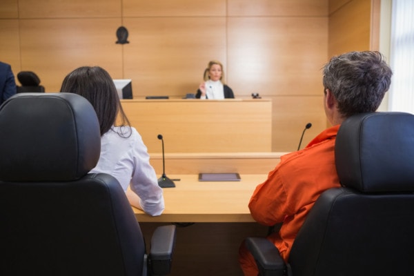 Lawyer and client listening to judge in the court room